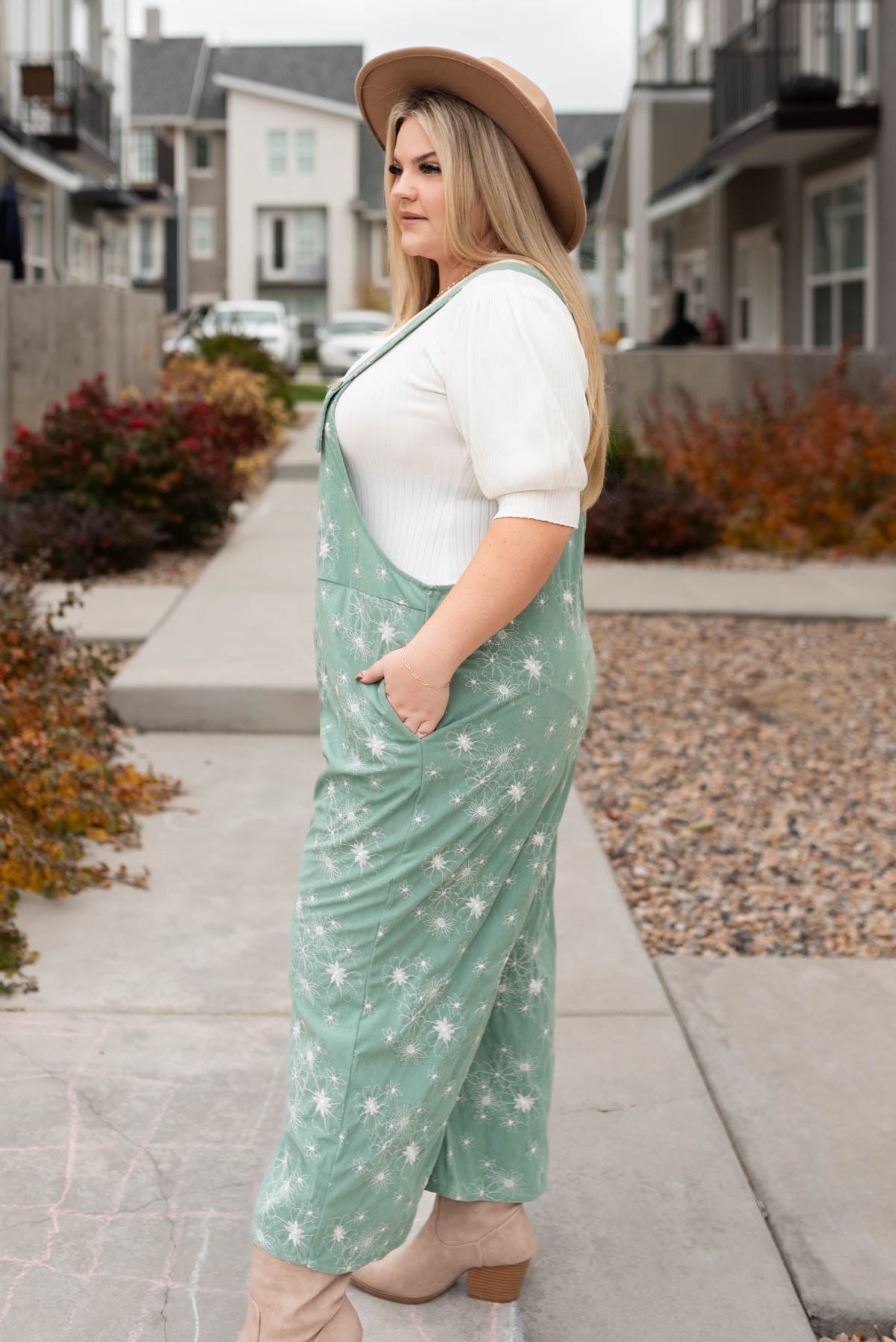 Side view of the plus size green overalls