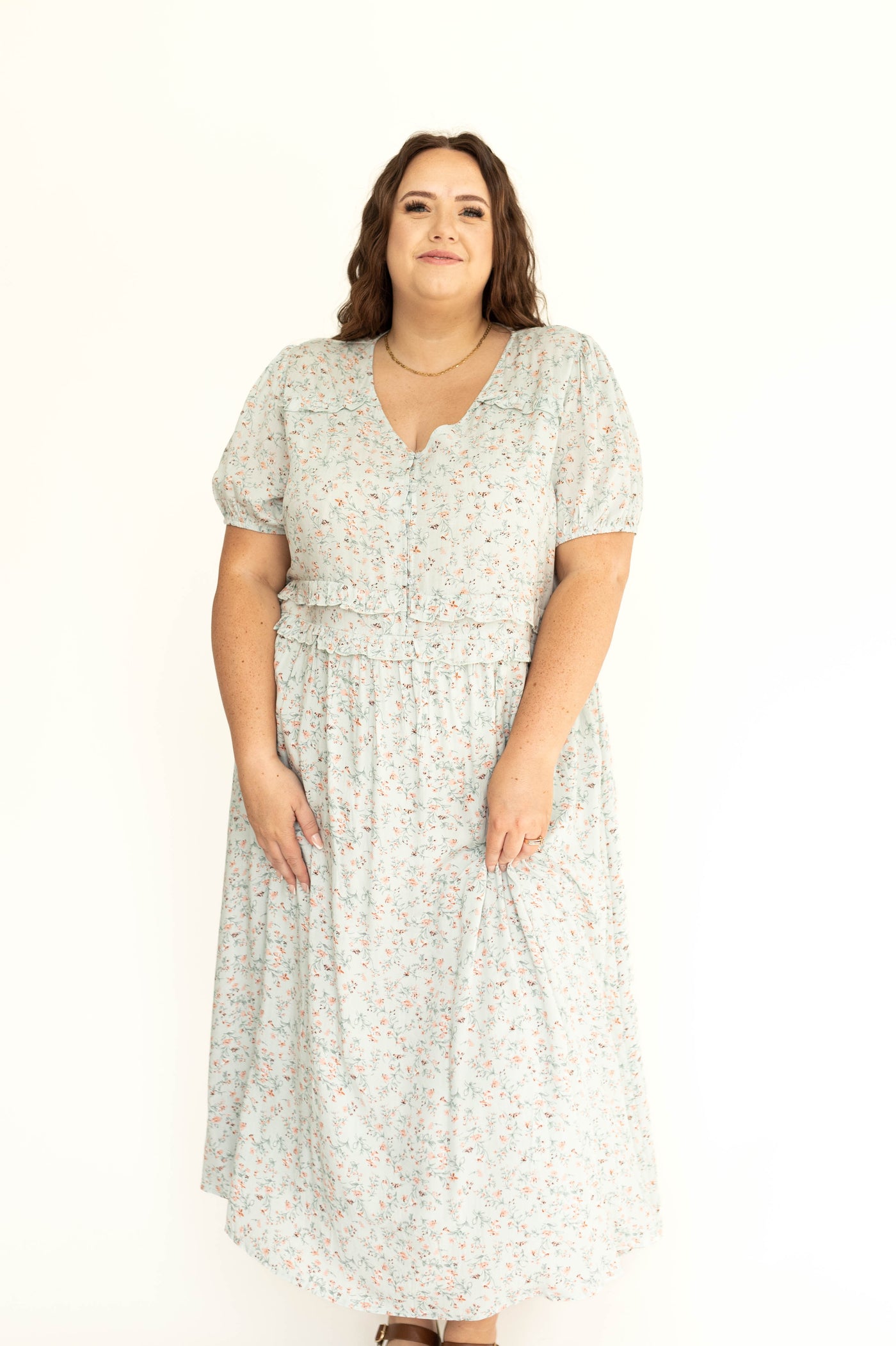 Front view of a plus size light seafoam short sleeve floral dress.