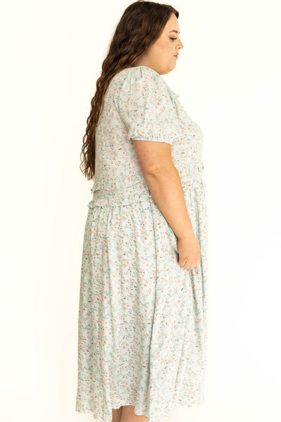 Side view of a plus size light seafoam short sleeve dress.