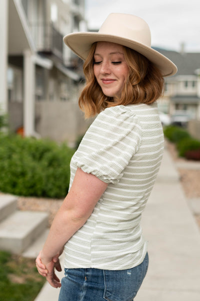 Side view of a sage stripe top