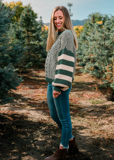 Sleeve view of the green stripe knit sweater