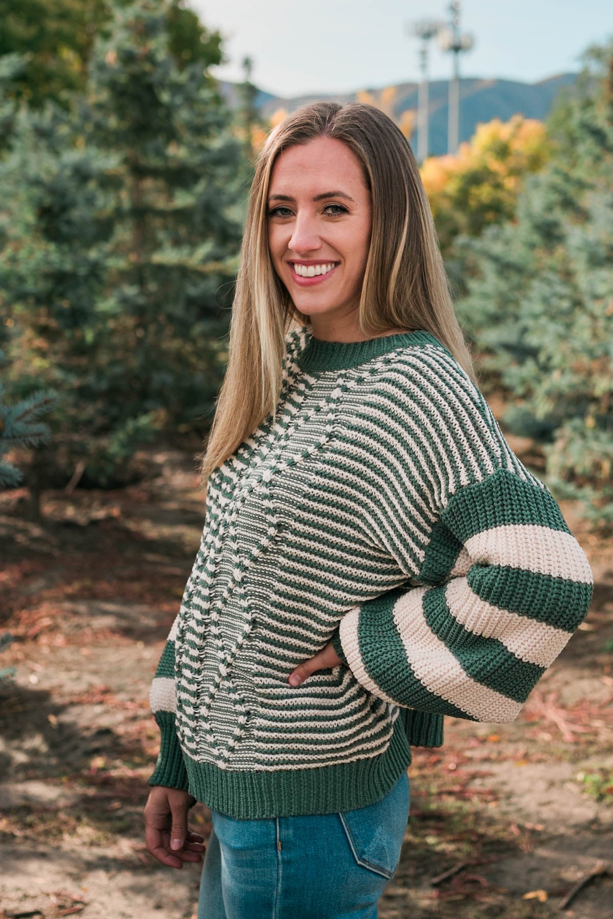 Side view of the green stripe knit sweater