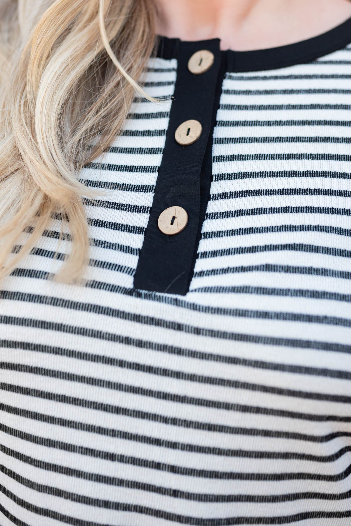 Close up of the buttons on a plus size black top
