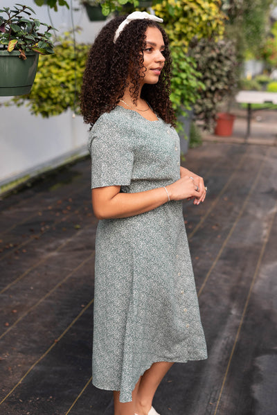Side view of the deep green button down dress