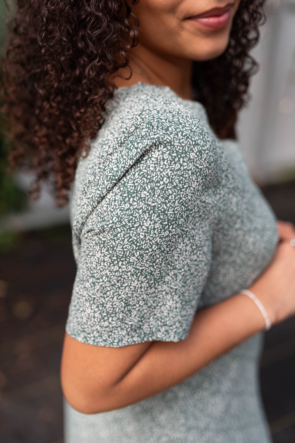 Close up of the sleeve on the deep green button down dress