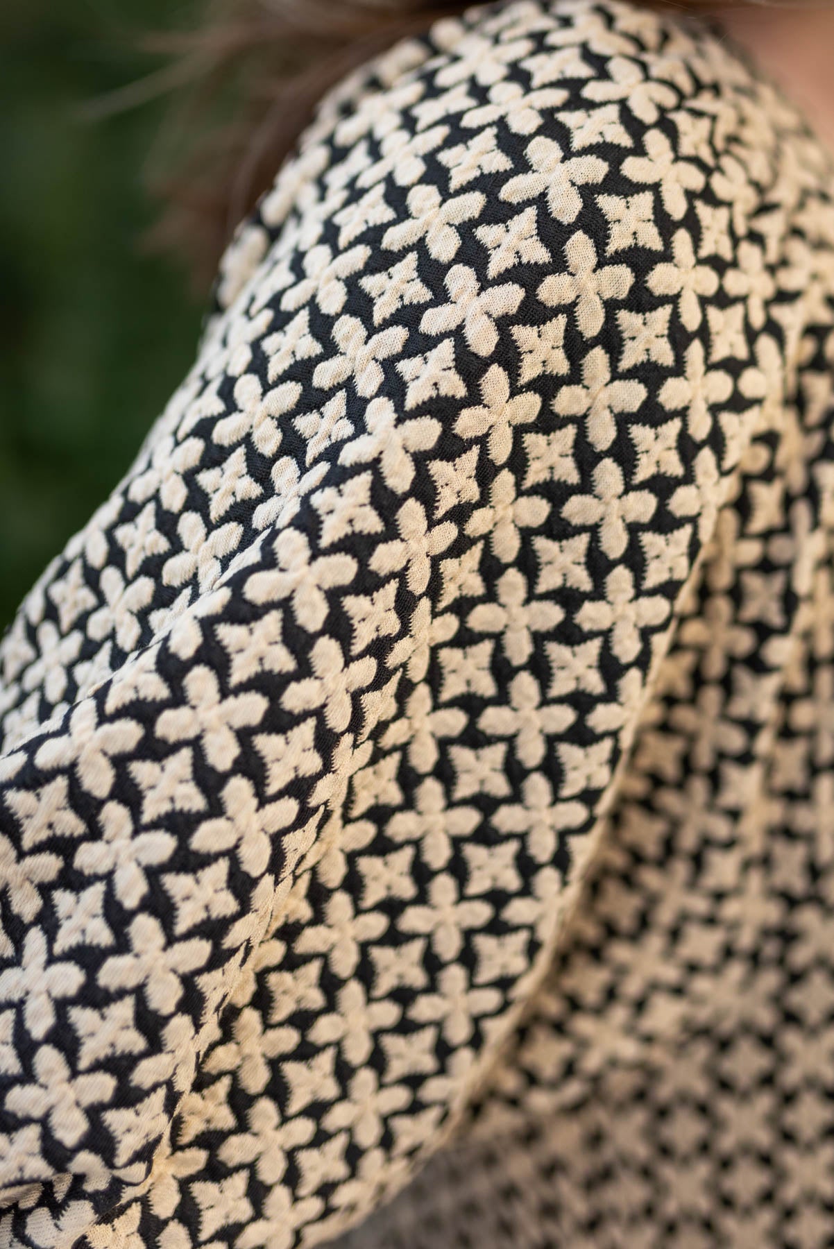 Close up of the fabric on a black pattern tiered dress