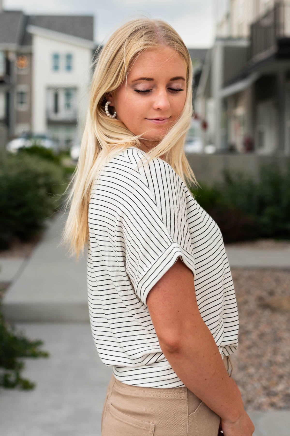 Side view of a short sleeve off white top
