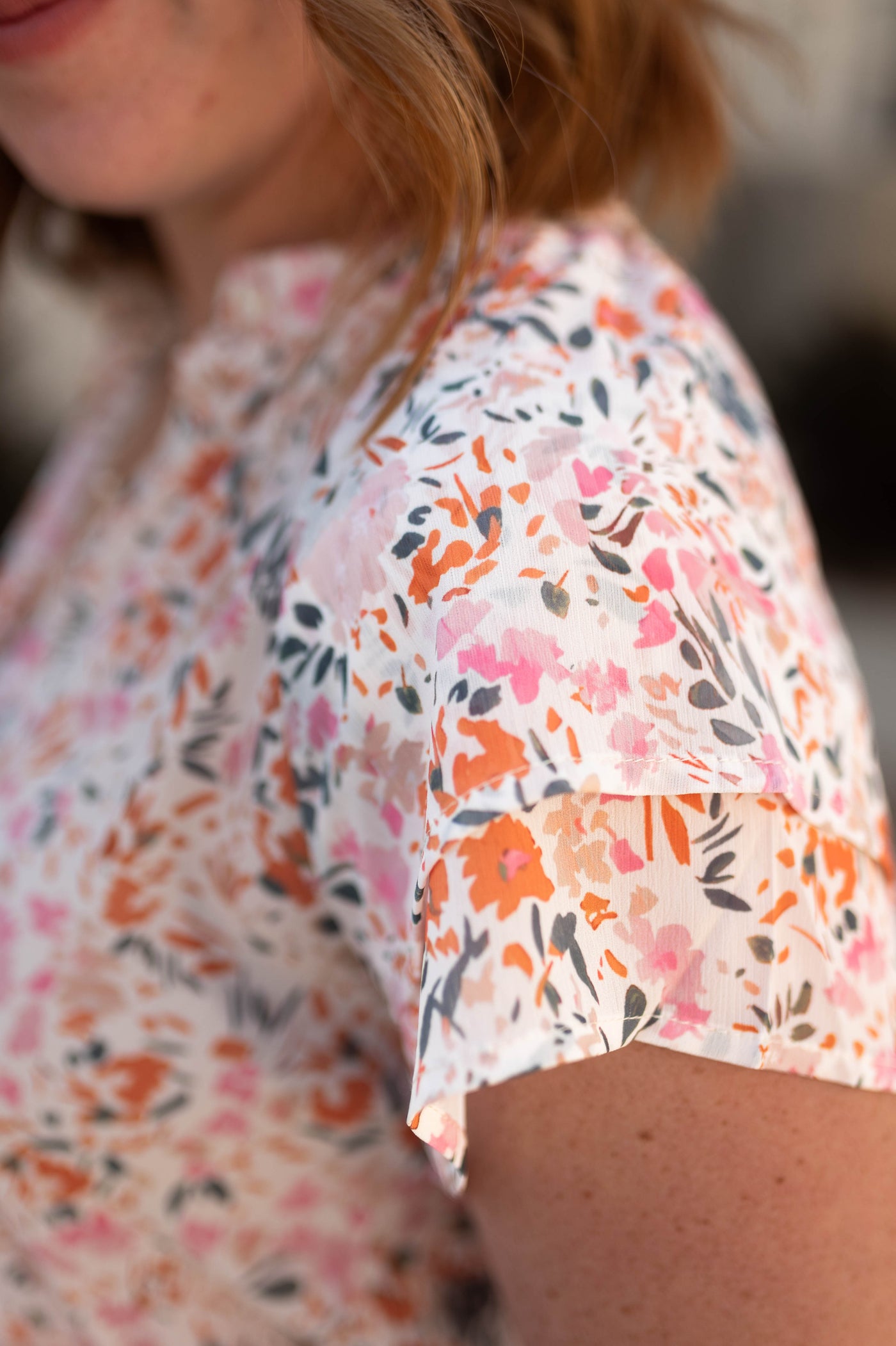 The sleeve of a ivory floral top