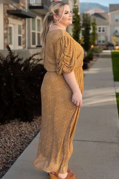 Side view of the plus size mustard dress with gathered sleeves