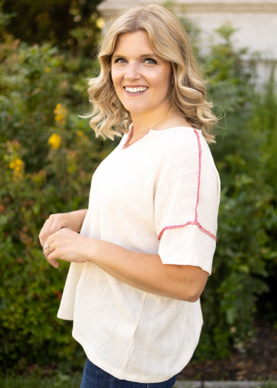 Short sleeve cream top with red edging