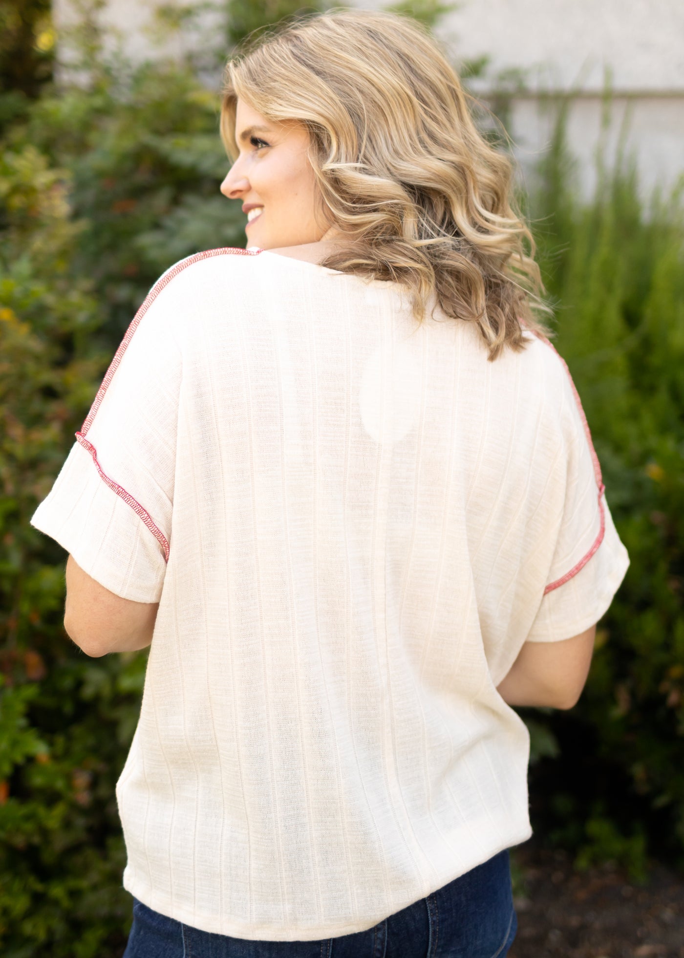 Back view of a short sleeve cream top