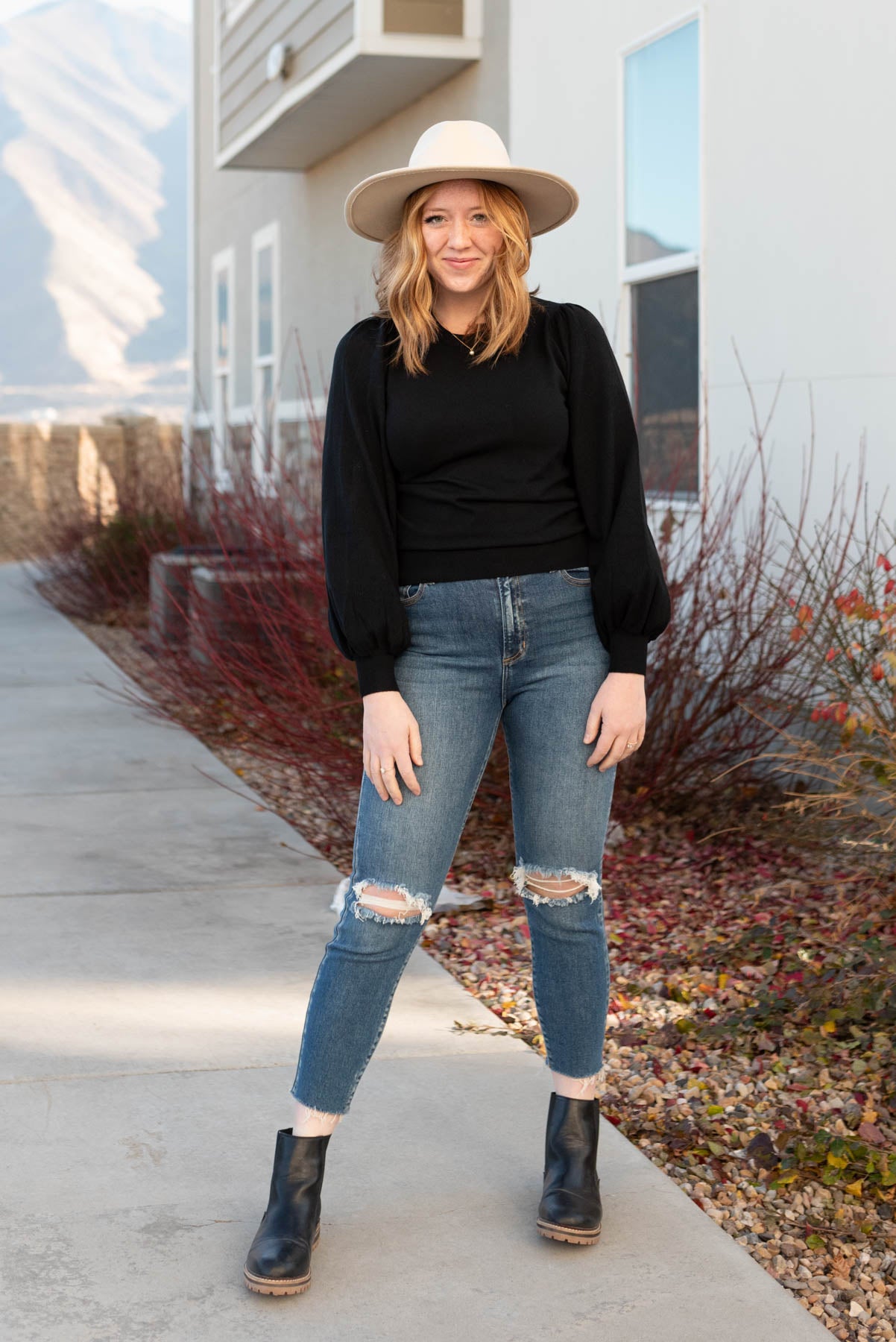 Front view of a medium black puff sleeve sweater