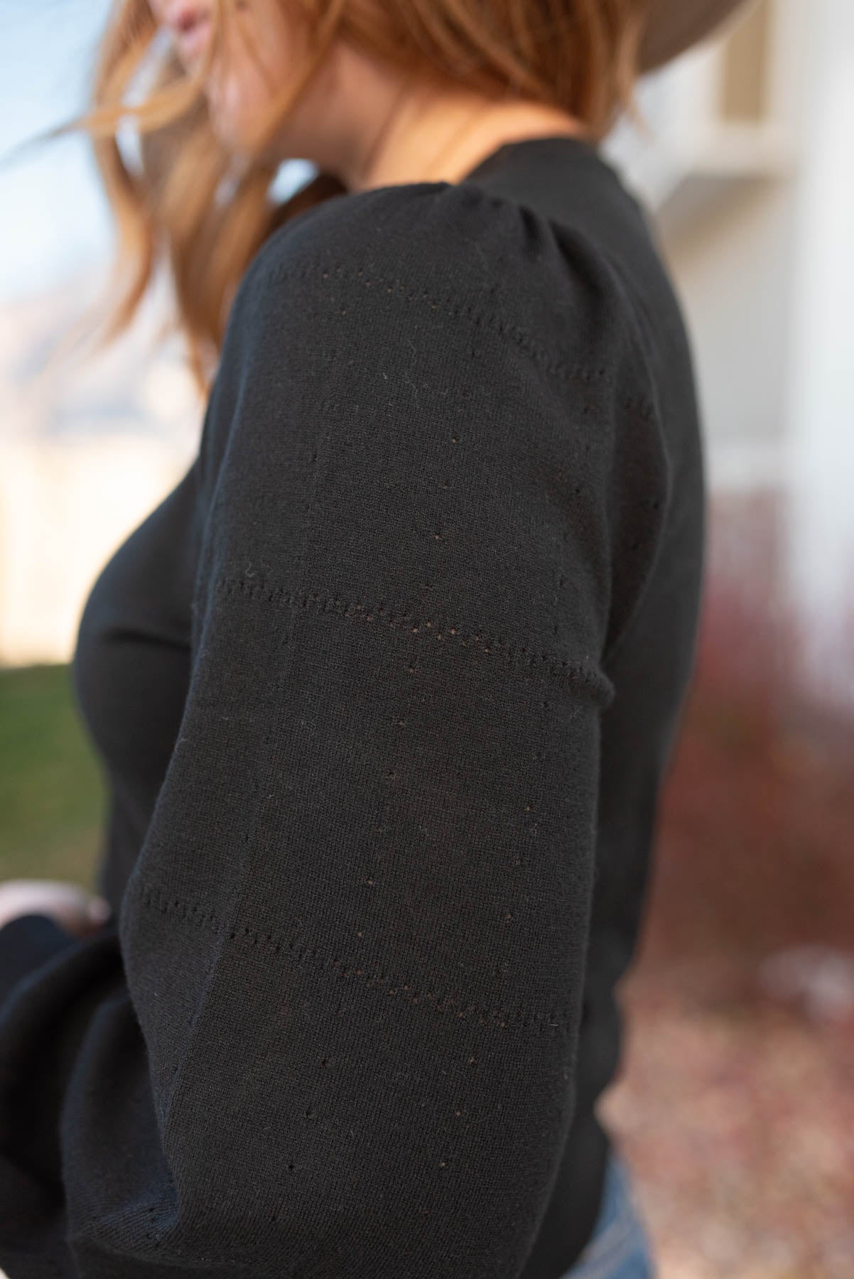 Close up of the sleeve on a black puff sleeve sweater