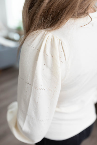 Close up of the patterned sleeve on the ivory puff sleeve sweater
