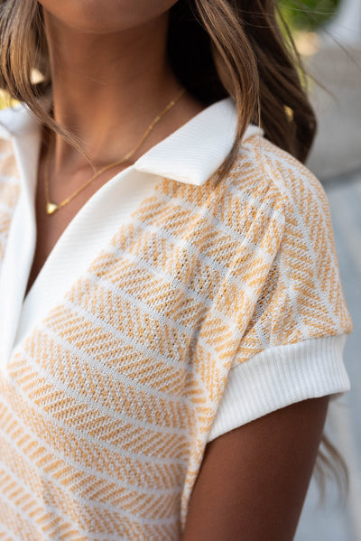 Close up of the collar and fabric on the yellow knit t-shirt dress