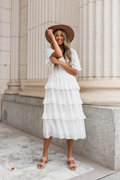 White tiered textured dress with ruffles on the skirt