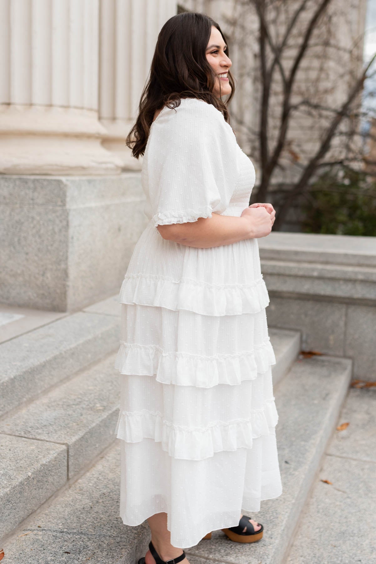 Side view of the plus size white tiered textured dress