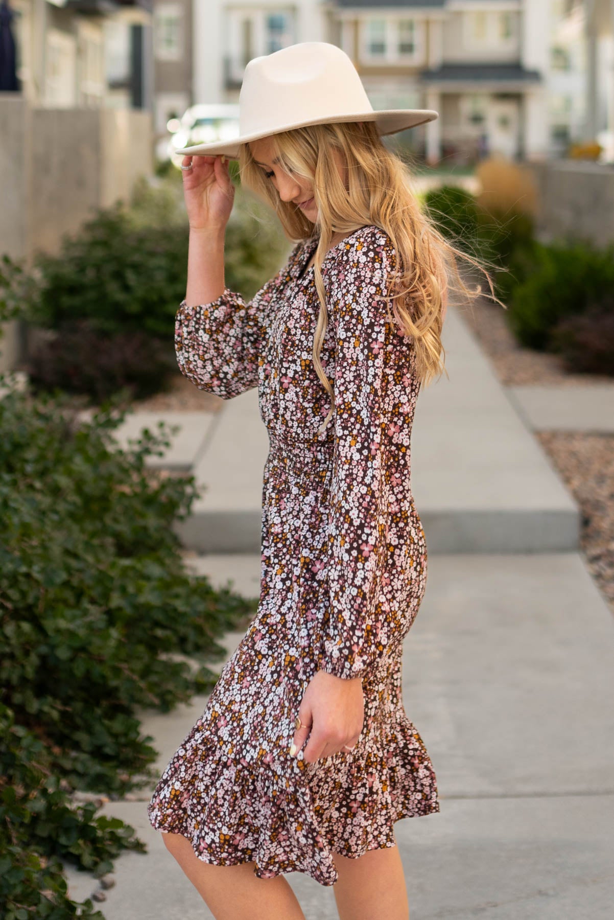 Long sleeve side view of a brown floral dress