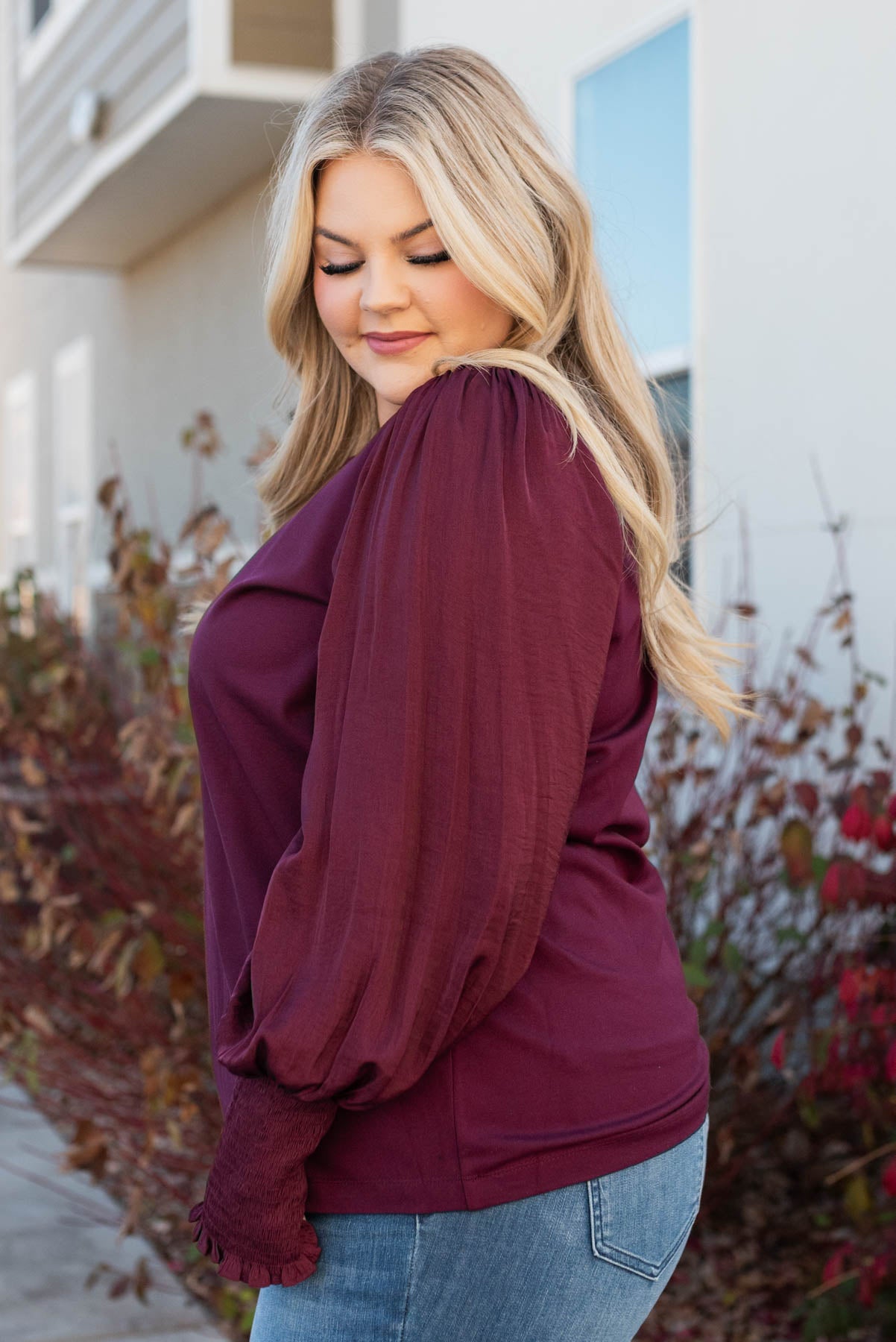 Side view of a plus size wine satin sleeve blouse