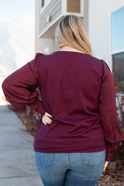 Back view of a plus size wine satin sleeve blouse