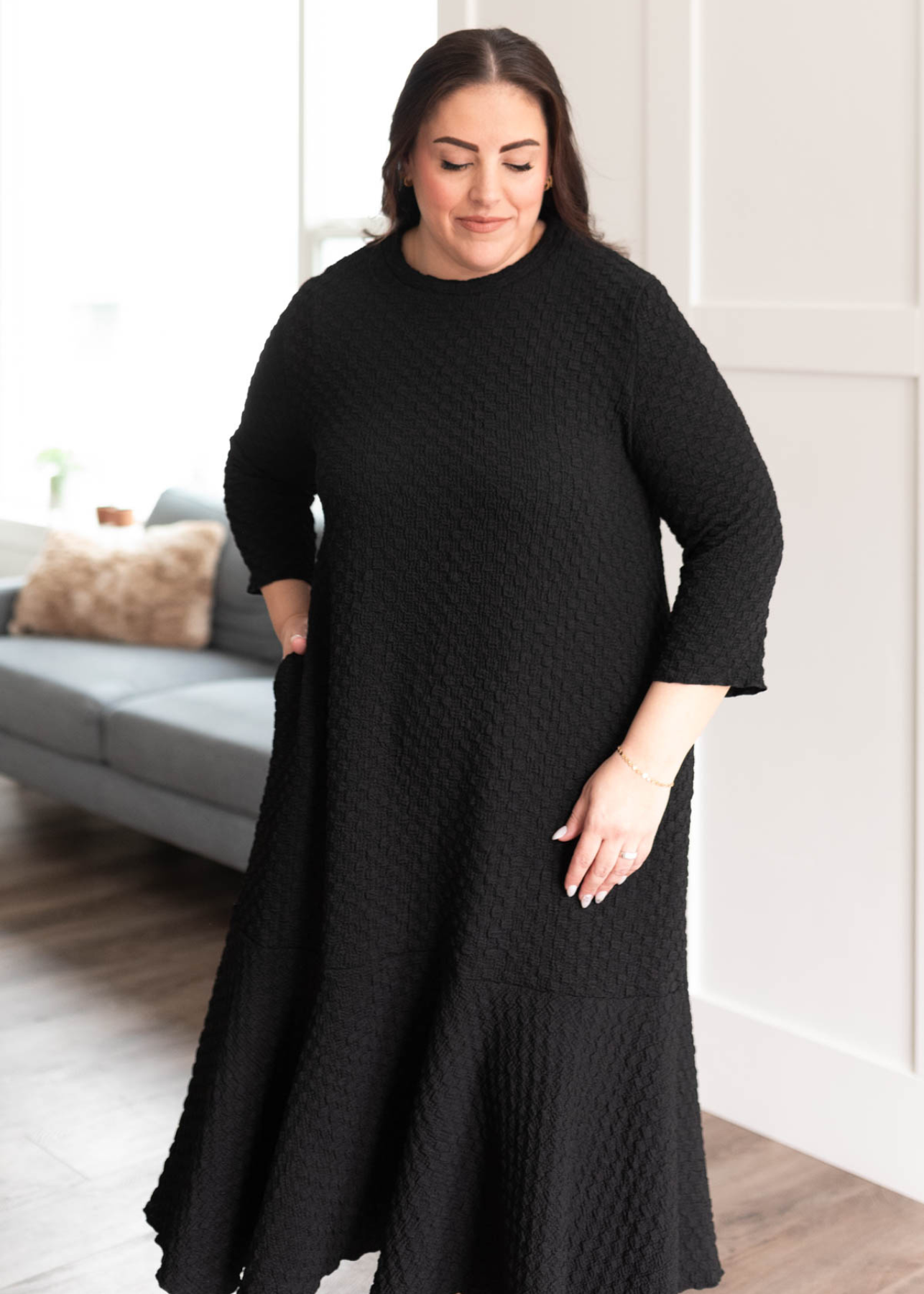 Plus size black textured ruffle hem dress with 3/4 sleeves