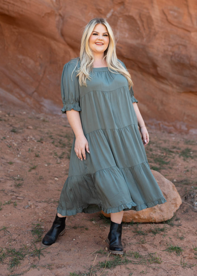 Plus size dark moss dress with a ruffle at the hem