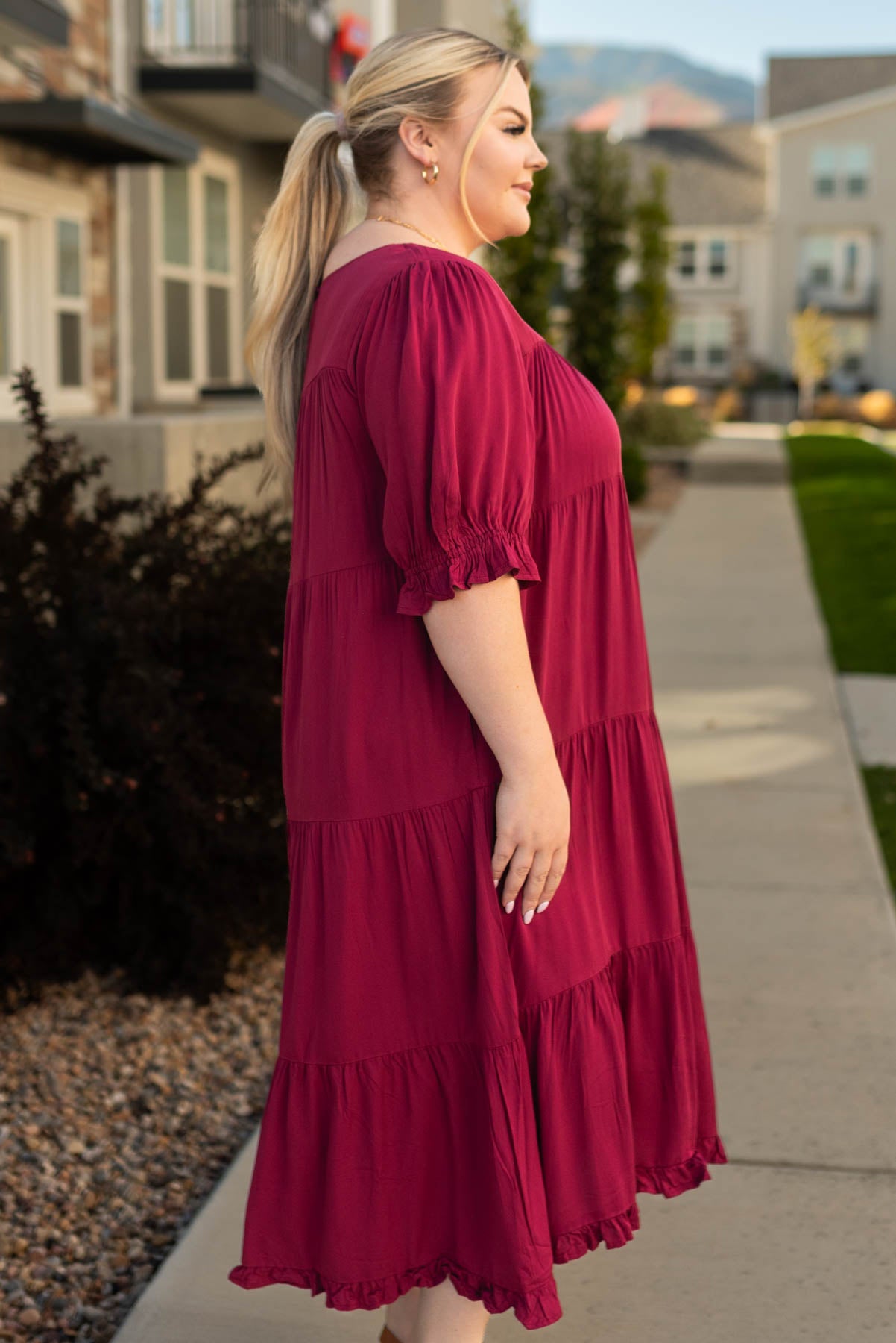 Side view of a plus size ruby red dress