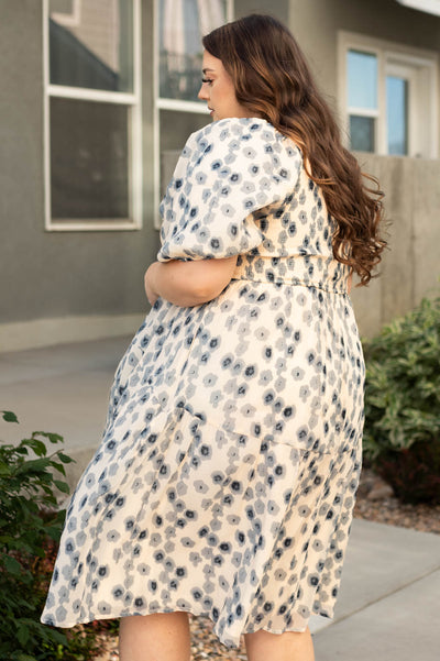 Side view of plus size blue dress with floral print