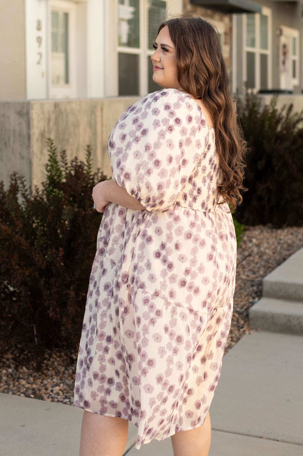 Side view of a short sleeve plus size lavender dress with floral print