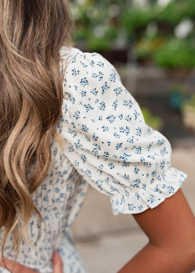 Close up of the sleeve and fabric on the blue floral smocked dress