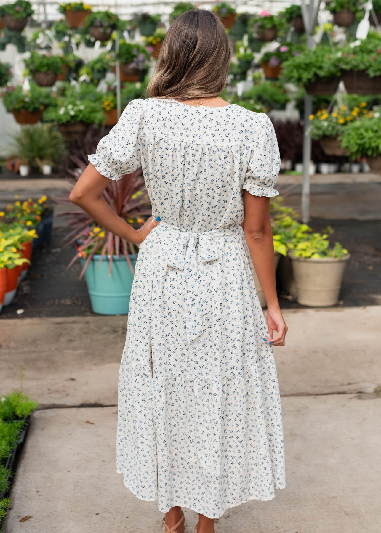 Back view of the blue floral smocked dress with tie at the waist