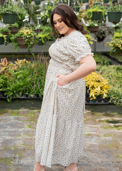 Side view of the blue floral smocked dress with pockets in plus size