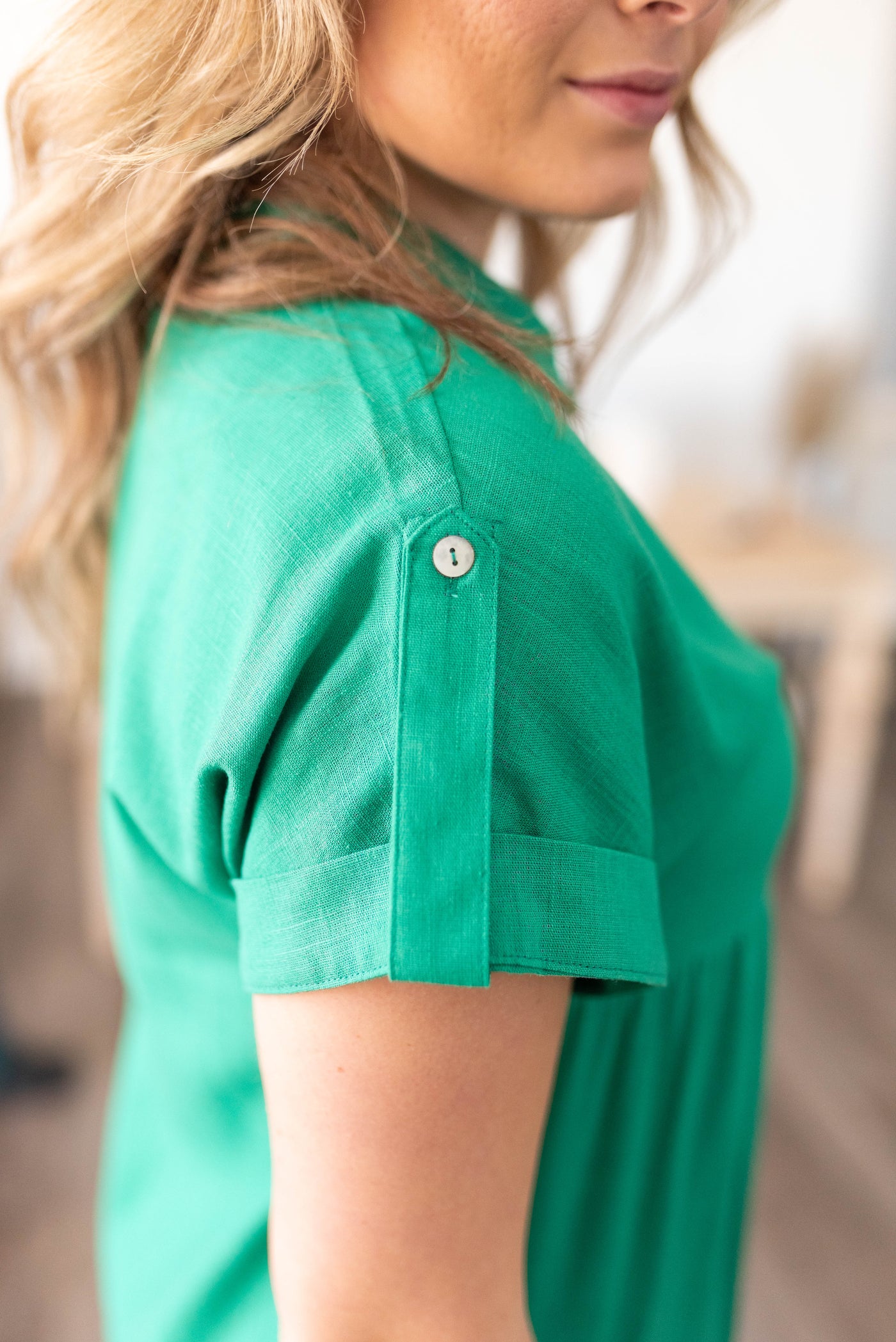 The sleeve detail on the green button down dress