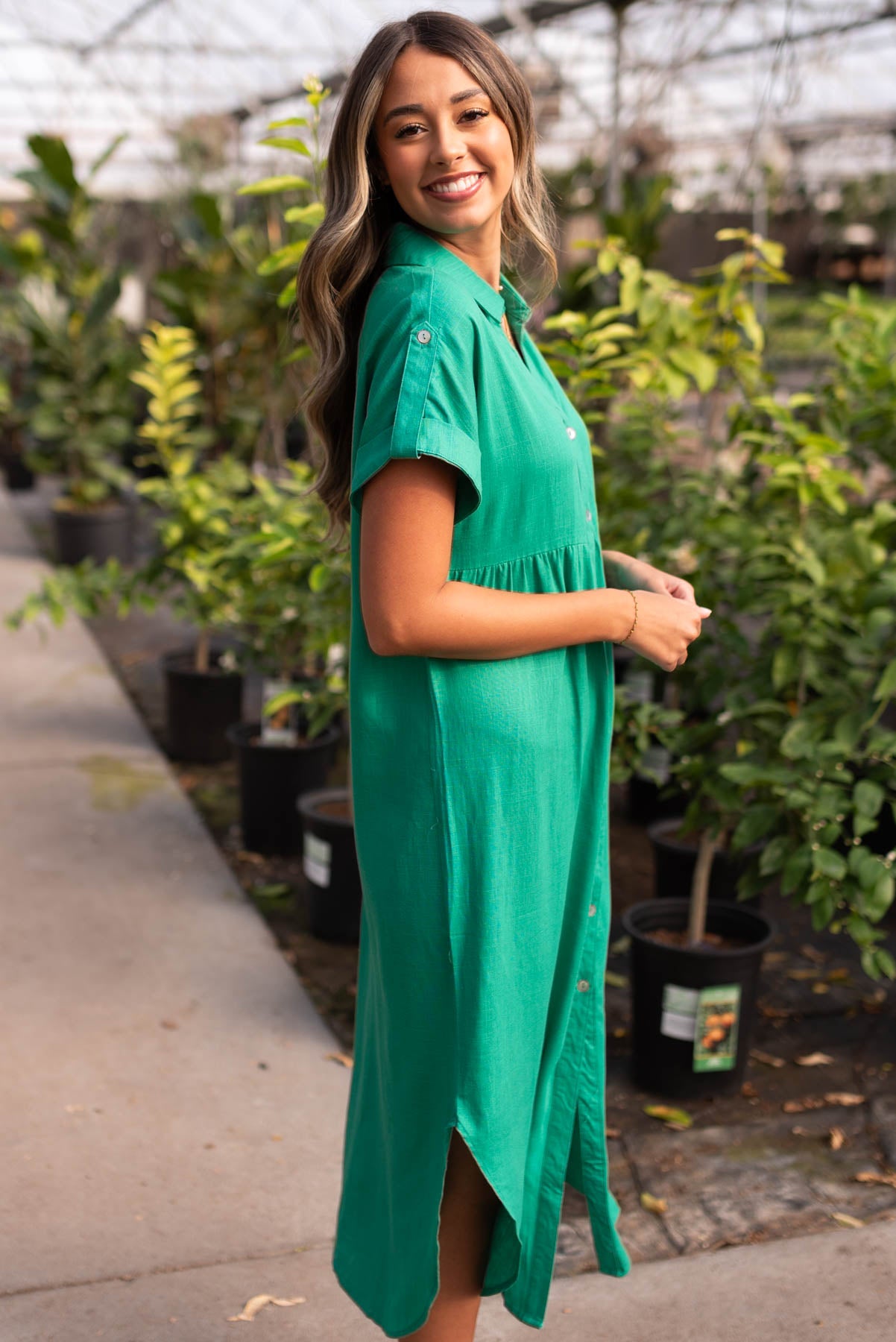 Side view of the green button down dress