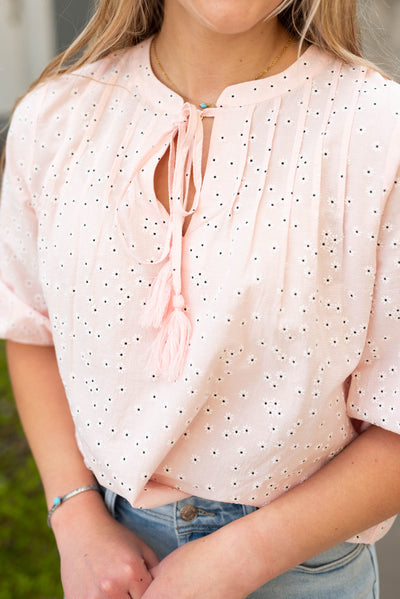 Pink floral woven blouse that ties at the neck