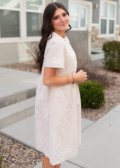Side view of the the embroidered gingham mini dress