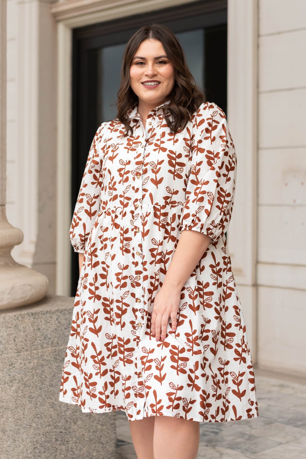 Brown floral dress with 3/4 sleeves and tiered skirt