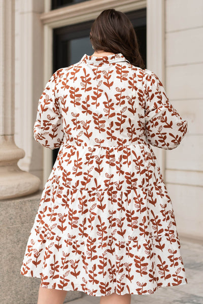 Back view of a plus size brown floral dress