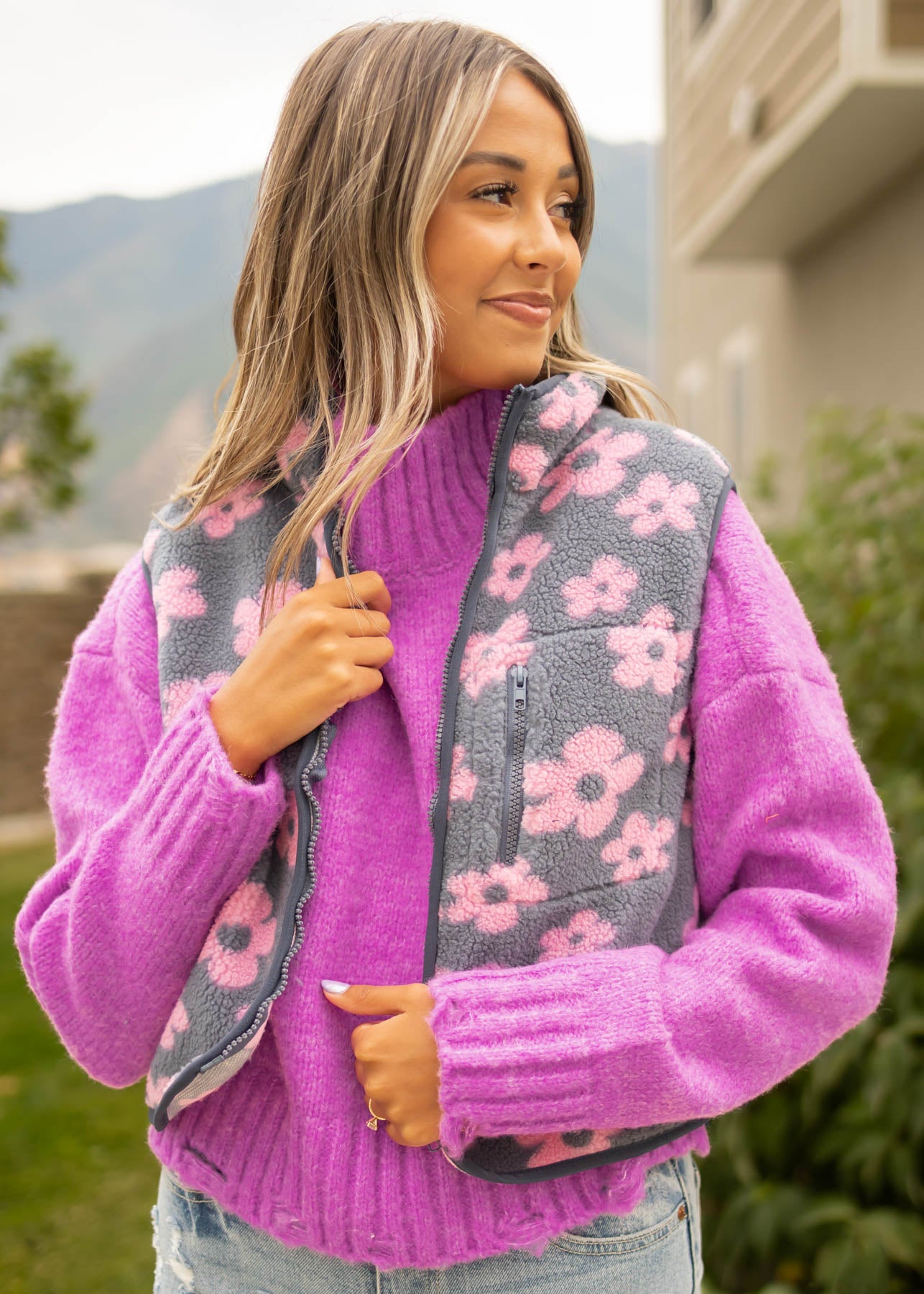 Front view of a denim fleece vest with pink flowers