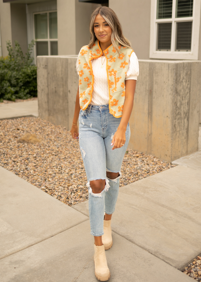 Orange fleece vest with flowers