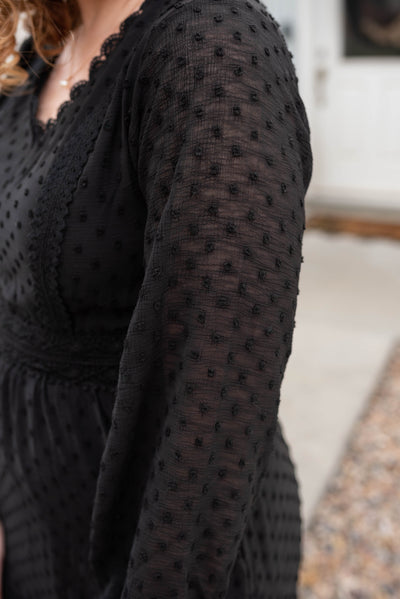 Sleeve view of the black textured dress