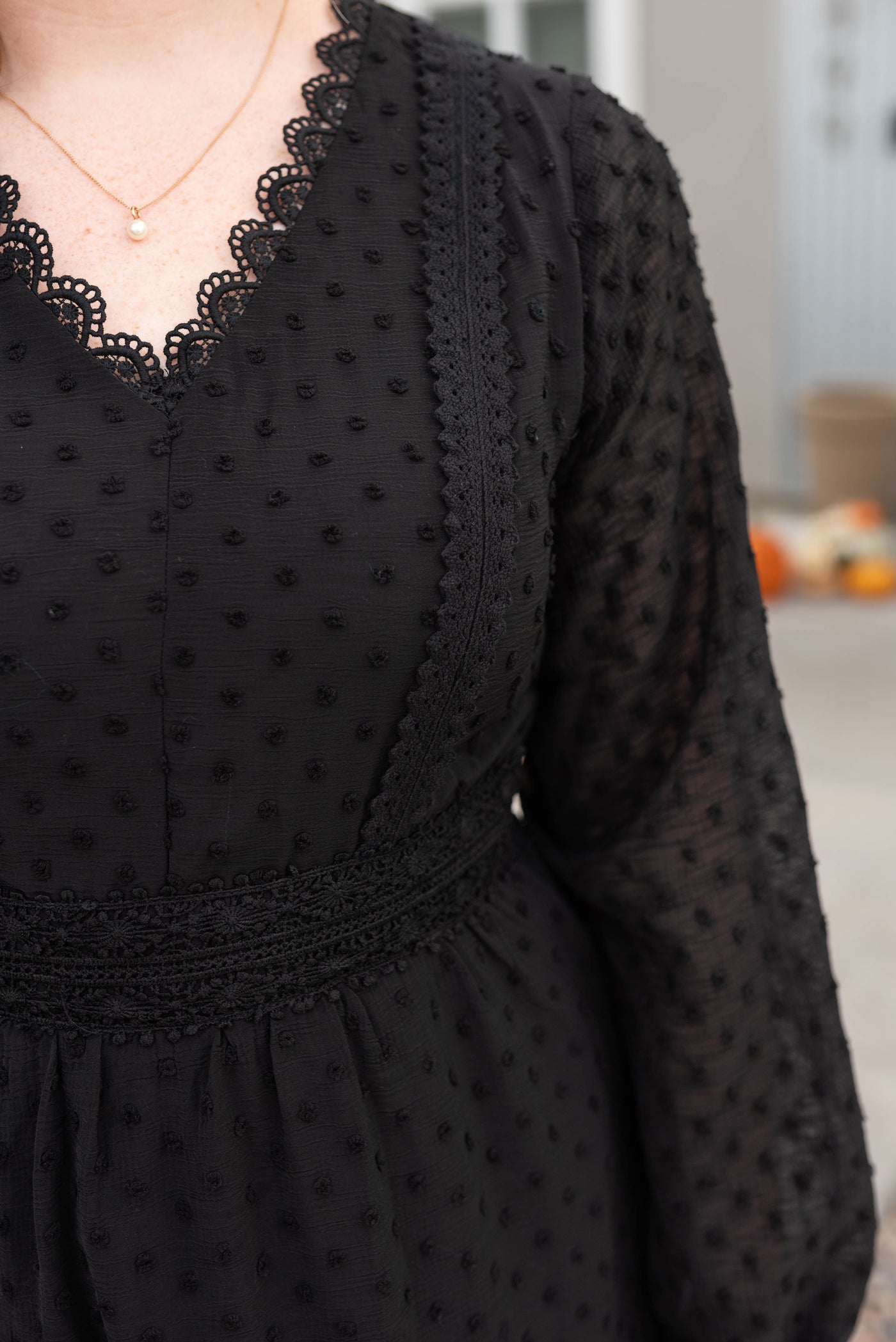 Close up of the fabric of the black textured dress