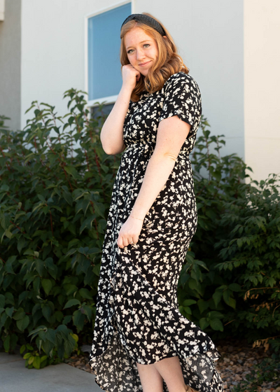 Side view of a short sleeve black floral dress