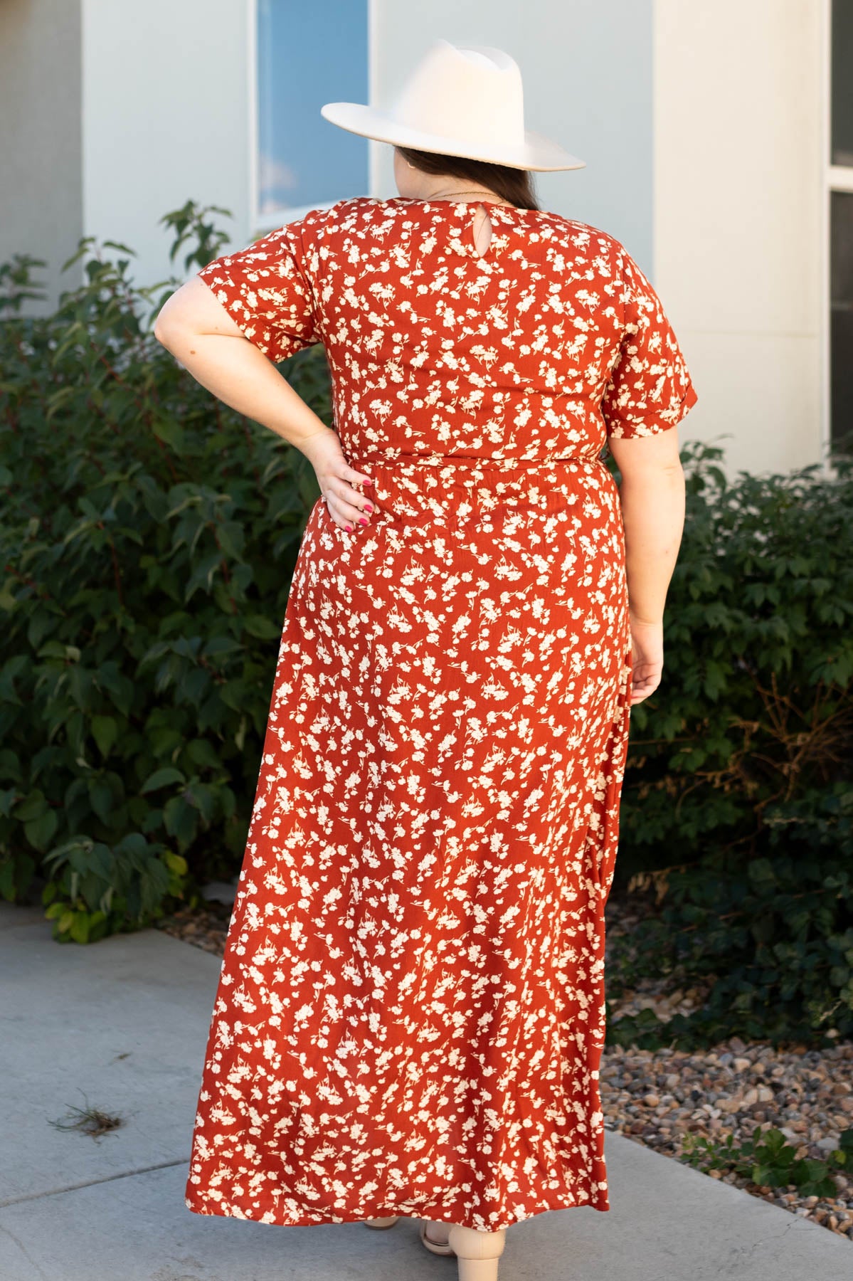 Back view of a plus size rust floral dress