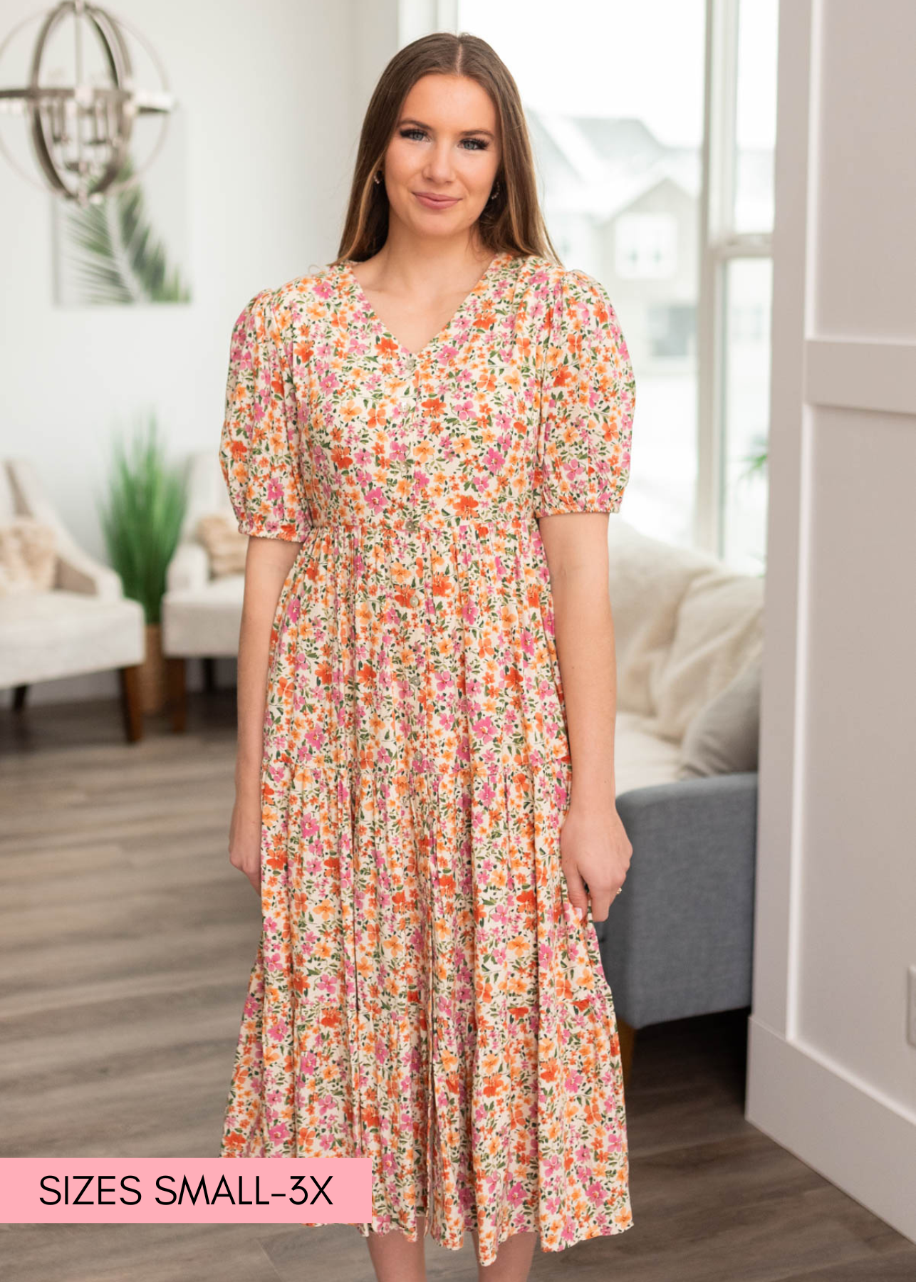 Apricot floral dress that buttons up and has short sleeves