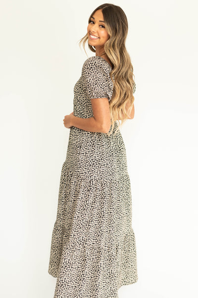 Side view of a black floral dress with full sleeves