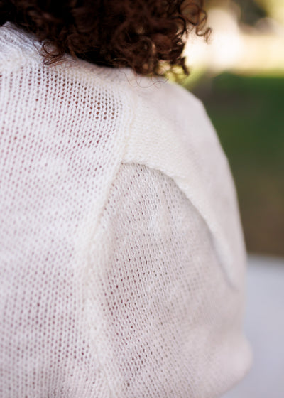 Close up of the knit on the ivory flag sweater top