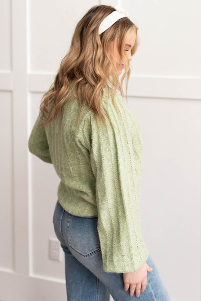 Side view of the light green puff sleeve sweater