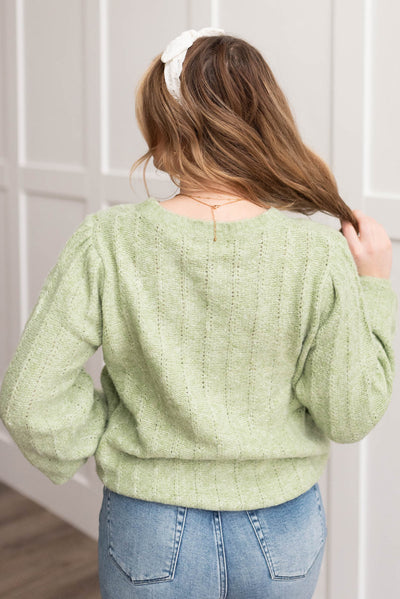 Back view of the light green puff sleeve sweater