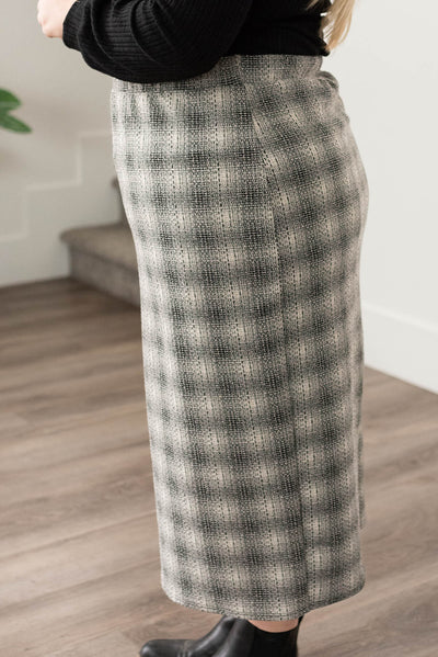 Side view of a plus size black plaid skirt